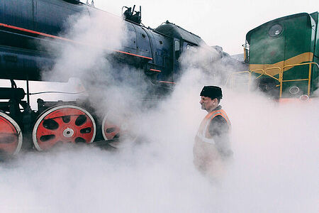 Machinist Igor Shugaev next to the last Soviet steam locomotive Lv-0522